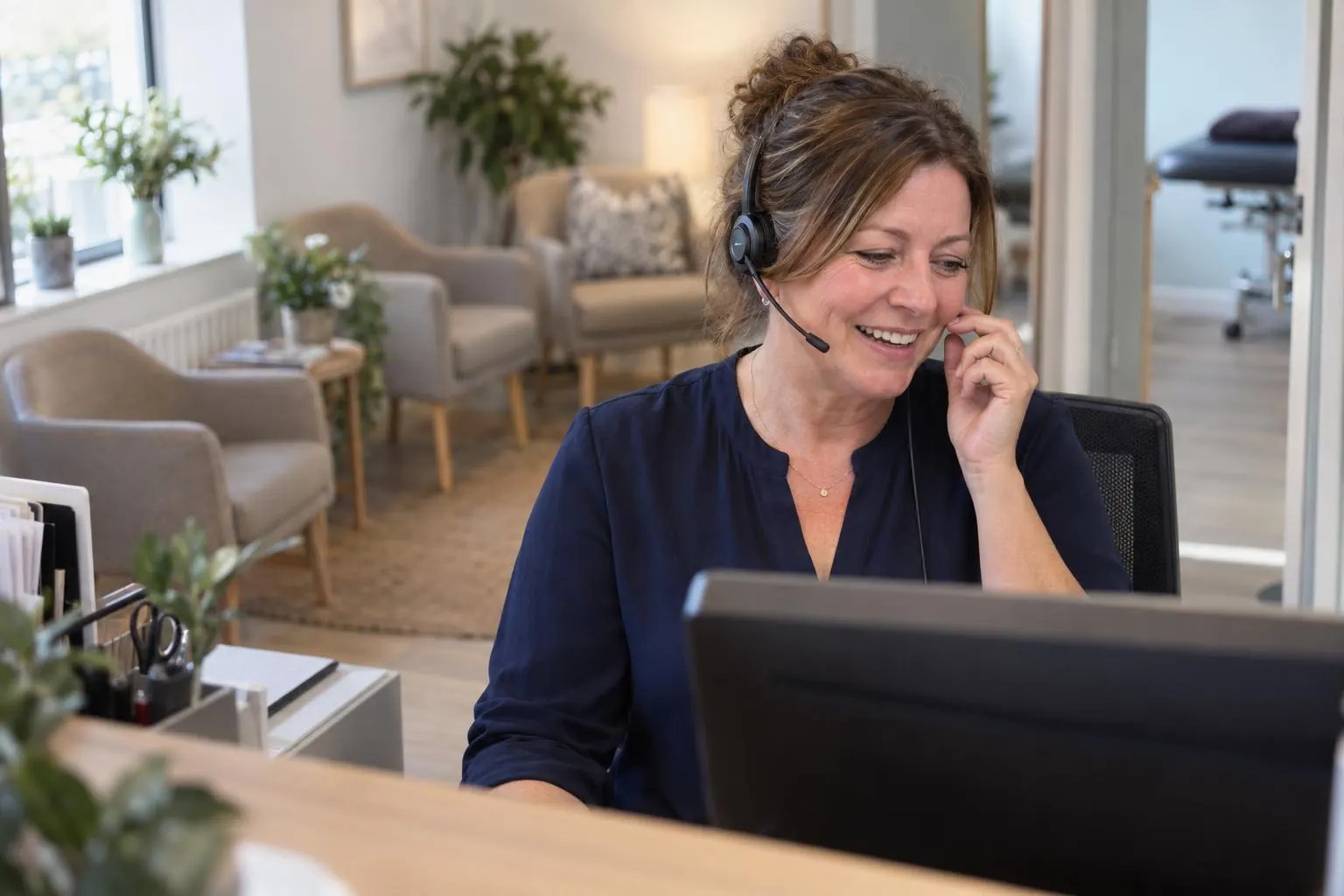 A clinic receptionist answering a call